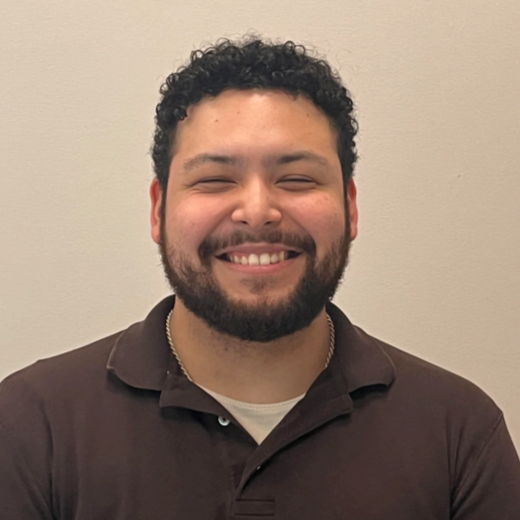 Chiropractic Lacey WA Otniel Meet The Team Otniel standing in front of a white wall smiling.